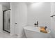 Modern bathroom with a soaking tub, walk-in shower with glass door, and sleek fixtures at 9205 Selkirk Ct, Indianapolis, IN 46260