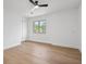 Bright bedroom with hardwood floors, diamond-paned window, ceiling fan, and double door closet at 9205 Selkirk Ct, Indianapolis, IN 46260