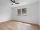 Bright bedroom featuring hardwood floors, a ceiling fan and a diamond-paned window at 9205 Selkirk Ct, Indianapolis, IN 46260