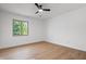 Bedroom featuring hardwood floors, diamond-paned window and a modern ceiling fan at 9205 Selkirk Ct, Indianapolis, IN 46260