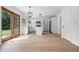 Open concept kitchen features white cabinets, stainless steel appliances, an island, and sliding doors to the backyard at 9205 Selkirk Ct, Indianapolis, IN 46260