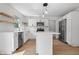 Well-lit kitchen features white cabinets, stainless steel appliances, a center island, and hardwood flooring at 9205 Selkirk Ct, Indianapolis, IN 46260