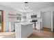 Modern kitchen features white cabinetry, stainless steel appliances, a center island, and stylish pendant lighting at 9205 Selkirk Ct, Indianapolis, IN 46260