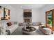 Elegant living room features a stone fireplace, white sofa, and a walk-out to the back yard at 9205 Selkirk Ct, Indianapolis, IN 46260