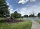 Community playground featuring swings and play structure, as well as mature trees and green lawn at 9205 Selkirk Ct, Indianapolis, IN 46260