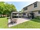 Backyard brick paver patio with a fire pit, gazebo and outdoor furniture at 9402 Thornwood Dr, Indianapolis, IN 46250
