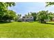 Spacious backyard featuring a trampoline, swing set, large lawn and patio at 9402 Thornwood Dr, Indianapolis, IN 46250