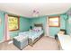 Bright bedroom with charming decor, a plush bed, and natural light from two windows at 9402 Thornwood Dr, Indianapolis, IN 46250