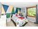 A cozy bedroom with geometric accent wall and a bright window view at 9402 Thornwood Dr, Indianapolis, IN 46250