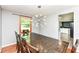 Dining area featuring a modern light fixture and access to an adjacent kitchen at 9402 Thornwood Dr, Indianapolis, IN 46250