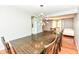 Bright dining room featuring a modern sputnik chandelier over a long dark wood table at 9402 Thornwood Dr, Indianapolis, IN 46250