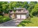 Charming two-story home with a two-car garage, landscaping and a brick entryway at 9402 Thornwood Dr, Indianapolis, IN 46250