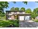 Two-story home with two-car garage, green door, and well-maintained lawn at 9402 Thornwood Dr, Indianapolis, IN 46250