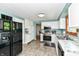 Open kitchen design with white cabinetry, stainless appliances, and view of breakfast bar at 9402 Thornwood Dr, Indianapolis, IN 46250
