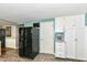 Kitchen showcasing sleek black fridge, marble countertops, and white pantry storage at 9402 Thornwood Dr, Indianapolis, IN 46250