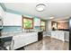 Spacious kitchen featuring white cabinets, ample counter space, and a double basin sink at 9402 Thornwood Dr, Indianapolis, IN 46250