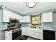 Well lit kitchen with white cabinetry, marble countertops, and stainless steel appliances at 9402 Thornwood Dr, Indianapolis, IN 46250