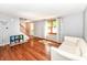 Spacious living room with hardwood floors, front window, and staircase access at 9402 Thornwood Dr, Indianapolis, IN 46250