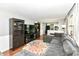 Open-concept living area with a gray sectional sofa, large TV, and bright natural light at 9402 Thornwood Dr, Indianapolis, IN 46250