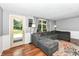Comfortable living room with sliding door, plush gray sectional, and hardwood floors at 9402 Thornwood Dr, Indianapolis, IN 46250