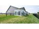 A house with a grey exterior and fenced backyard shows the patio at 9671 Holborn Ave, McCordsville, IN 46055