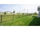 Spacious backyard featuring a black metal fence surrounding lush green grass at 9671 Holborn Ave, McCordsville, IN 46055