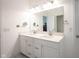 Clean bathroom with a large mirror over a double vanity sink and ample lighting at 9671 Holborn Ave, McCordsville, IN 46055