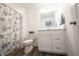 Bright bathroom featuring a white vanity with a modern sink and stylish wood-look tile flooring at 9671 Holborn Ave, McCordsville, IN 46055