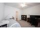 Neutral bedroom/office with carpet, ceiling fan, dark wood desk, and white trim, offering versatility and comfort at 9671 Holborn Ave, McCordsville, IN 46055