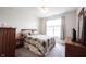Cozy bedroom with a neutral color scheme, a ceiling fan, and carpeted floors at 9671 Holborn Ave, McCordsville, IN 46055