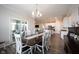 View of dining area, kitchen, and living area with lots of natural light, creating a warm and inviting atmosphere at 9671 Holborn Ave, McCordsville, IN 46055