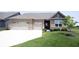 Charming brick home boasts a well-manicured lawn, two-car garage, and inviting front entrance at 9671 Holborn Ave, McCordsville, IN 46055
