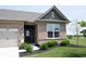 Close-up of a charming brick home featuring a two-car garage, and inviting front door entrance at 9671 Holborn Ave, McCordsville, IN 46055