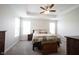 Spacious main bedroom featuring tray ceilings, a ceiling fan, neutral colors, and carpeted floors at 9671 Holborn Ave, McCordsville, IN 46055