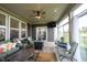 This is a covered patio featuring a ceiling fan, comfortable seating, and a fire pit for outdoor relaxation and entertaining at 9671 Holborn Ave, McCordsville, IN 46055