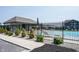 Glimpse of the pool area from behind the fence shows lounge seating and shade at 9671 Holborn Ave, McCordsville, IN 46055