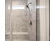 Close up of a marble tiled walk-in shower with a built-in bench and shower head at 9671 Holborn Ave, McCordsville, IN 46055