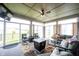 Inviting sunroom with lots of windows, neutral furniture and a rug, creating a cozy relaxing space at 9671 Holborn Ave, McCordsville, IN 46055