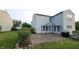 Spacious backyard featuring a brick patio with an outdoor seating area and a grill at 10042 Pine Grove Way, Indianapolis, IN 46234