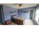 This bedroom features a ceiling fan and blue walls at 10042 Pine Grove Way, Indianapolis, IN 46234