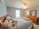 Bedroom with light blue walls, dresser and comfortable queen sized bed at 10042 Pine Grove Way, Indianapolis, IN 46234