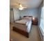 This bedroom features soft blue walls and a plush bed at 10042 Pine Grove Way, Indianapolis, IN 46234