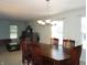 Spacious dining room with chandelier, neutral walls and two large windows at 10042 Pine Grove Way, Indianapolis, IN 46234