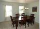 Bright dining room features a wood table, seating for six and chandelier lighting at 10042 Pine Grove Way, Indianapolis, IN 46234
