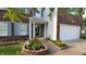 Attractive home with manicured flower beds lining the walkway and blue shutters at 10042 Pine Grove Way, Indianapolis, IN 46234