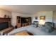 Cozy living room with a fireplace, comfortable seating, and a television at 10042 Pine Grove Way, Indianapolis, IN 46234