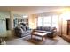 Open-concept living room with a view of the kitchen and comfortable seating arrangements at 10042 Pine Grove Way, Indianapolis, IN 46234