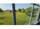 View out of the window overlooking a large, well-manicured lawn at 10042 Pine Grove Way, Indianapolis, IN 46234