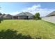 Expansive backyard featuring a well-maintained lawn and a view of the home's exterior at 1019 White Oak Dr, Plainfield, IN 46168