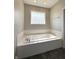 A bathtub in bathroom features white tile at 1019 White Oak Dr, Plainfield, IN 46168